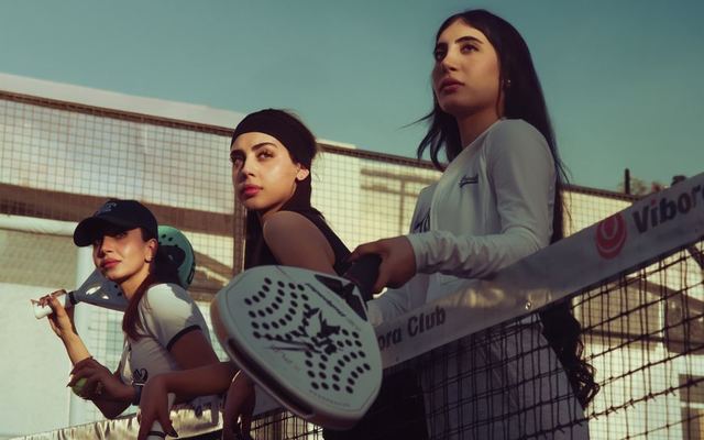 Three women play padel tennis at a court in Baghdad, Iraq.