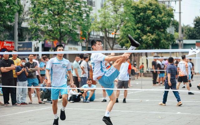 Exciting sepak takraw match in an urban park with energetic athletes demonstrating agility and skill.